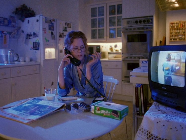Kidman as Alice Harford in  Eyes Wide Shut  (1999); her television plays a movie about a cheating husband, while she talks on the phone to her husband who is attempting to cheat